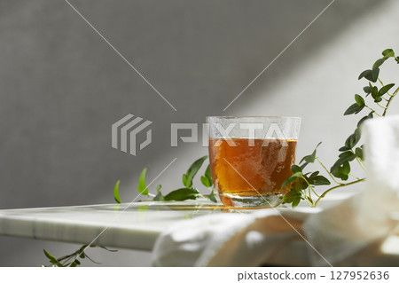 Minimal Aesthetic Beverages in Natural Light with Greenery. 127952636