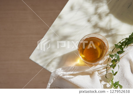 Minimal Aesthetic Beverages in Natural Light with Greenery. Minimal Aesthetic Beverages in Natural Light with Greenery. 127952638