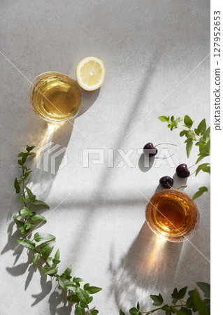 Minimal Aesthetic Beverages in Natural Light with Greenery. 127952653