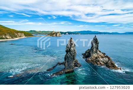 Stunning coastal landscape at sunrise with distinct rock formations and clear ocean waters Stunning coastal landscape at sunrise with distinct rock formations and clear ocean waters 127953020