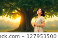 Thai woman in simple traditional dress standing under the tree 127953500