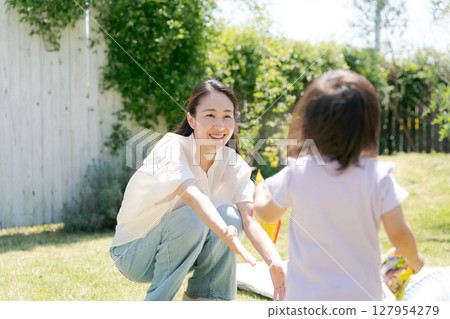 Parent and child playing in the park Parent and child playing in the park 127954279
