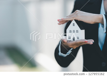 Woman hand hold key buy home model business concept involves sell financial management investment bank loan ownership income economy finance investments purchasing apartment blur background estate Woman hand hold key buy home model business concept involves sell financial management investment bank loan ownership income economy finance investments purchasing apartment blur background estate 127955162