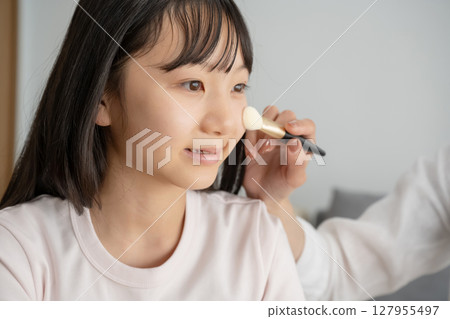 Girl getting her mother's makeup done Girl getting her mother's makeup done 127955497