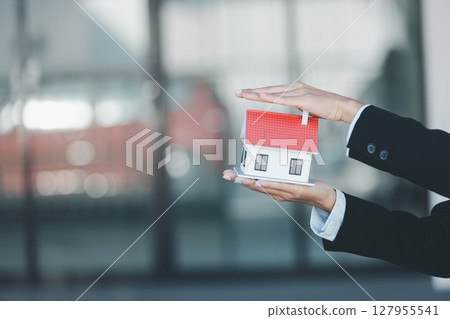 Woman hand hold key buy home model business concept involves sell financial management investment bank loan ownership income economy finance investments purchasing apartment blur background estate 127955541