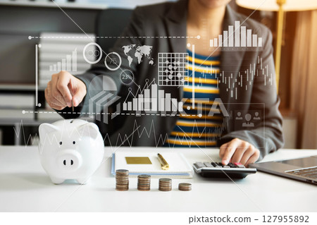 Business woman hand putting money coin into piggy bank with step of growing stack coins for saving money with virtual icon Business woman hand putting money coin into piggy bank with step of growing stack coins for saving money with virtual icon 127955892