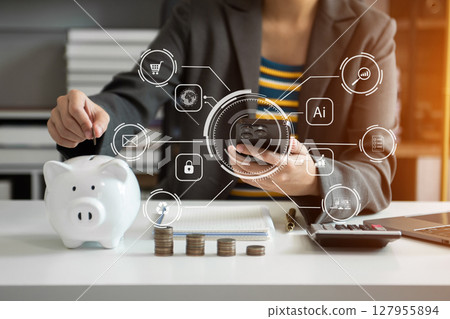 Business woman hand putting money coin into piggy bank with step of growing stack coins for saving money with virtual icon 127955894