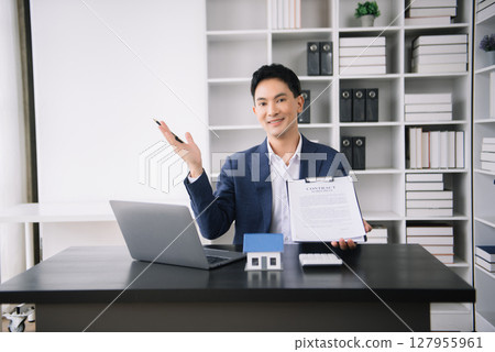 Asian man working with House model real estate agent and customer discussing for contract to buy house, insurance or loan real estate consult concerning mortgage loan offer 127955961