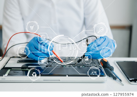 Electronics technician, electronic engineering electronic repair,electronics measuring and testing, repair and maintenance concepts.uses a voltage meter to check and upgrade in shop 127955974