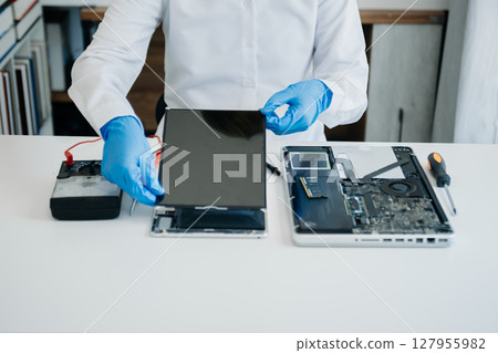Electronics technician, electronic engineering electronic repair,electronics measuring and testing, repair and maintenance concepts.uses a voltage meter to check and upgrade in shop Electronics technician, electronic engineering electronic repair,electronics measuring and testing, repair and maintenance concepts.uses a voltage meter to check and upgrade in shop 127955982