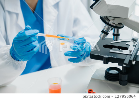 Modern medical research laboratory. female scientist working with micro pipettes analyzing biochemical samples, advanced science chemical laboratory 127956064