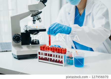 Modern medical research laboratory. female scientist working with micro pipettes analyzing biochemical samples, advanced science chemical laboratory Modern medical research laboratory. female scientist working with micro pipettes analyzing biochemical samples, advanced science chemical laboratory 127956070