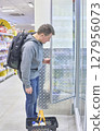 Student With Backpack Checks Grocery Cooler Display 127956073