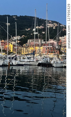 Vibrant Coastal Marina with Colorful Waterfront Buildings Vibrant Coastal Marina with Colorful Waterfront Buildings 127956329