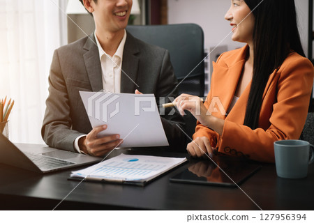 Businessman and team analyzing financial statement Finance task. with smart phone and laptop and tablet. Wealth management concept Businessman and team analyzing financial statement Finance task. with smart phone and laptop and tablet. Wealth management concept 127956394