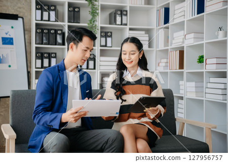 Portrait of success business people working together in home office. Couple teamwork startup concept 127956757