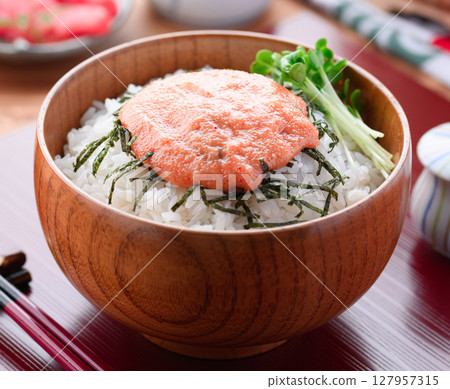 A delicious photo of a Japanese lunch with mentaiko rice served in a wooden bowl A delicious photo of a Japanese lunch with mentaiko rice served in a wooden bowl 127957315