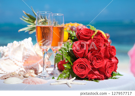 Celebrate love with roses, champagne, and seaside beauty. Perfect for wedding or engagement settings. Celebrate love with roses, champagne, and seaside beauty. Perfect for wedding or engagement settings. 127957717
