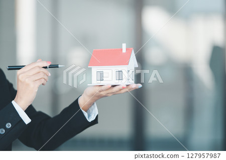 Woman hand hold key buy home model business concept involves sell financial management investment bank loan ownership income economy finance investments purchasing apartment blur background estate Woman hand hold key buy home model business concept involves sell financial management investment bank loan ownership income economy finance investments purchasing apartment blur background estate 127957987