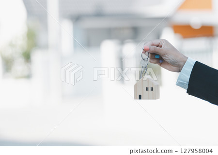 Woman hand hold key buy home model business concept involves sell financial management investment bank loan ownership income economy finance investments purchasing apartment blur background estate Woman hand hold key buy home model business concept involves sell financial management investment bank loan ownership income economy finance investments purchasing apartment blur background estate 127958004