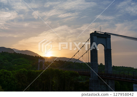 Sun rising over the Wind Suspension Bridge, Togawa Park 127958042