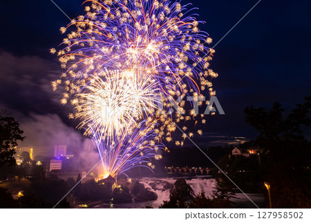 Fantastic fireworks at the Rhine Falls during the Swiss National Day celebrations on August 1 in Neuhausen am Rheinfall, Schaffhausen canton, Switzerland 127958502