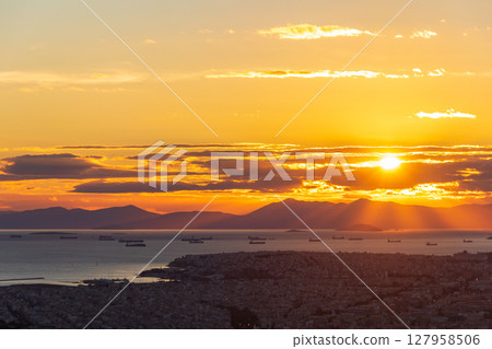 A breathtaking view of the sunset over the city of Athens, Greece from the top of the Lycabettus hill A breathtaking view of the sunset over the city of Athens, Greece from the top of the Lycabettus hill 127958506