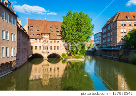 The building of Heilig Geist Spital (Holy Spirit Hospital) located on the Pegnitz river in Nuremberg, Germany 127958542