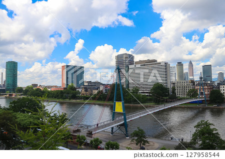 Frankfurt am Main skyline with skyscrapers and bridge over the Main river, Germany Frankfurt am Main skyline with skyscrapers and bridge over the Main river, Germany 127958544