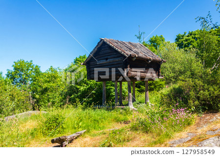 Small hut or storehouse built by Sami people on a high planks in Skansen open-air museum in Stockholm, Sweden 127958549