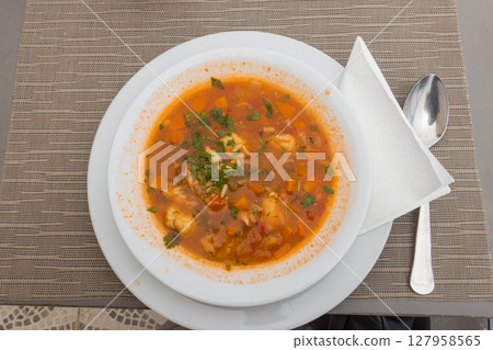 Fish soup on a table in a restaurant Fish soup on a table in a restaurant 127958565