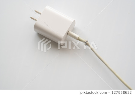 Dangerous electrical cord with broken plug 127958632