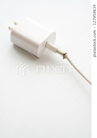 Dangerous electrical cord with broken plug 127958634