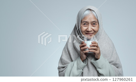 Indonesian grandmother smiles with milk Indonesian grandmother smiles with milk 127960261