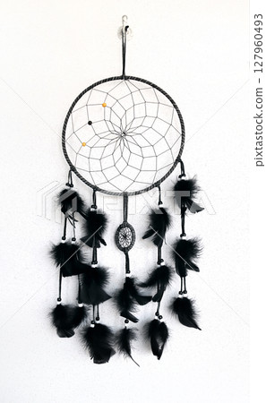 Dream catcher on stucco wall. Magic dreamcatcher on white wall background. A traditional Native American shaman amulet Dream catcher on stucco wall. Magic dreamcatcher on white wall background. A traditional Native American shaman amulet 127960493