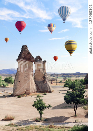 Balloon flight, famous tourist attraction of Cappadocia. Air balloons and Fairy Chimney in Pasabag Valley, Anatolia, Turkey. Popular destination for travellers seeking an adventure and natural beauty 127960501