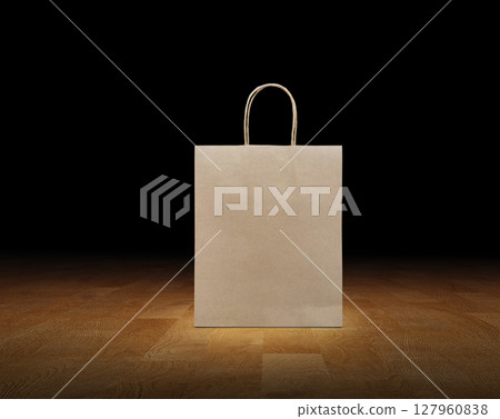 Empty brown kraft paper bag isolated on black wooden background. 127960838