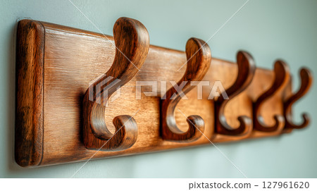 Wall mounted wooden coat rack on the wall 127961620