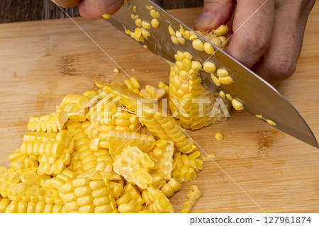 The process of making corn soup from freshly harvested corn: Removing the kernels The process of making corn soup from freshly harvested corn: Removing the kernels 127961874