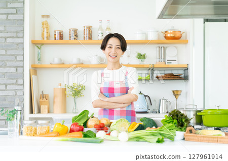 Housewife in kitchen apron Housewife in kitchen apron 127961914