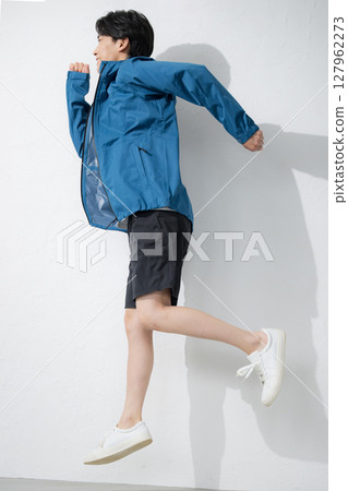 Full body of a man in sportswear running and jumping pose. Exercise is fun. Full body of a man in sportswear running and jumping pose. Exercise is fun. 127962273