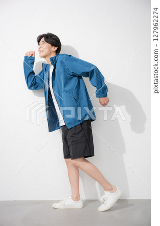 Full body of a man in sportswear running and jumping pose. Exercise is fun. 127962274