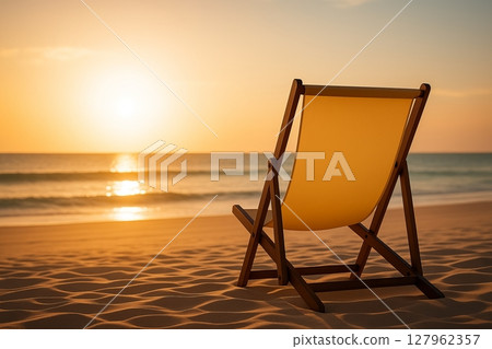 Empty Beach Chair Facing Sunset over the Sea 127962357