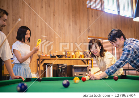 Man and woman playing billiards 127962404