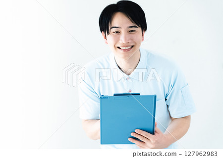 A man working as a caregiver holding a file 127962983