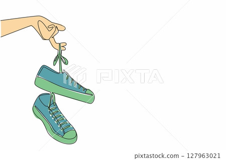 Single continuous line drawing a pair of sneakers with laces hanging from the fingers. Easy to carry. Attracts attention. National Two Different Colored Shoes Day. One line design vector illustration Single continuous line drawing a pair of sneakers with laces hanging from the fingers. Easy to carry. Attracts attention. National Two Different Colored Shoes Day. One line design vector illustration 127963021