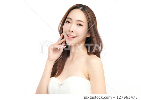 A beautiful young Asian woman with clean, fresh skin against a white background. Skincare, facial treatment, cosmetology, beauty, and spa. An elegant portrait of an Asian woman. A beautiful young Asian woman with clean, fresh skin against a white background. Skincare, facial treatment, cosmetology, beauty, and spa. An elegant portrait of an Asian woman. 127963473