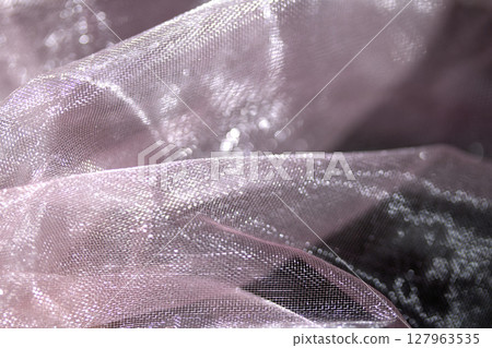 Close up of pink organza silk fabric in delicate waves for background 127963535