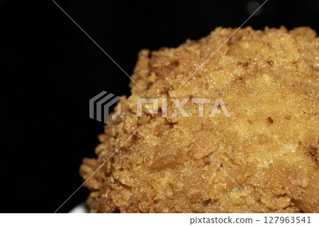 Crispy Scotch Egg Batter Fried Golden Close up with runny yolk 127963541