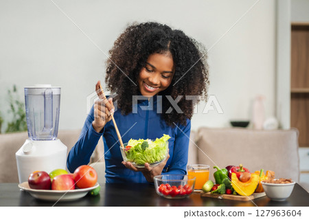Fit woman enjoys healthy fruit breakfast after yoga training. fitness, nutrition, home lifestyle. 127963604